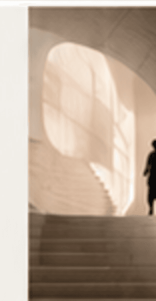 A lone figure climbing a pale stone staircase towards an arched window filled with light
